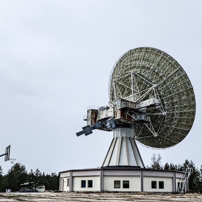 A large satellite dish used for communication and astronomy in an outdoor setting.